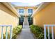Inviting walkway leads to the front door between two units, featuring well-maintained landscaping and charming curb appeal at 2002 Bal Harbor Blvd # 311, Punta Gorda, FL 33950