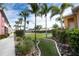 Scenic green space between the buildings, featuring landscaping, palm trees and sidewalks at 2002 Bal Harbor Blvd # 311, Punta Gorda, FL 33950
