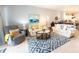 Bright living room featuring tiled floors and open floor plan to kitchen and dining area at 2002 Bal Harbor Blvd # 311, Punta Gorda, FL 33950