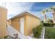 Attached storage unit with white door and exterior light, adjacent to walkway and landscaping at 2002 Bal Harbor Blvd # 311, Punta Gorda, FL 33950
