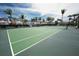 Well-maintained tennis court surrounded by lush landscaping and palm trees for recreational enjoyment at 2002 Bal Harbor Blvd # 311, Punta Gorda, FL 33950