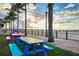 Waterfront with a scenic view of a pier and palm trees and colorful picnic tables by the shore at 2002 Bal Harbor Blvd # 311, Punta Gorda, FL 33950