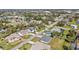 Aerial view showcases the neighborhood, highlighting the well-maintained homes and lush green landscaping at 206 Santarem Cir, Punta Gorda, FL 33983