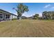 Expansive backyard with manicured lawn, lush greenery, and picturesque view at 206 Santarem Cir, Punta Gorda, FL 33983