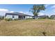 Expansive backyard featuring a patio area, lush lawn, and mature trees, great for relaxation and recreation at 206 Santarem Cir, Punta Gorda, FL 33983