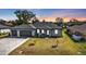 Charming exterior view of the home with a three car garage, manicured lawn, and well-maintained landscaping at 206 Santarem Cir, Punta Gorda, FL 33983