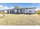 Lovely home featuring a three-car garage and a well-manicured front yard with fresh landscaping and green lawn at 206 Santarem Cir, Punta Gorda, FL 33983
