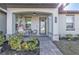 Inviting front porch with cozy seating, decorative plants, and a charming entrance to the home at 206 Santarem Cir, Punta Gorda, FL 33983