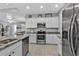 Kitchen featuring stainless steel appliances and view into the dining room and entryway at 206 Santarem Cir, Punta Gorda, FL 33983