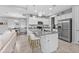 Stylish kitchen featuring a granite island with seating, stainless steel appliances, and modern pendant lighting at 206 Santarem Cir, Punta Gorda, FL 33983