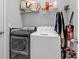 Laundry room with washer, dryer, and overhead shelving for storage at 206 Santarem Cir, Punta Gorda, FL 33983