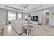 Cozy living room with a neutral color palette, large windows, and a seamless flow to the outdoor space at 206 Santarem Cir, Punta Gorda, FL 33983