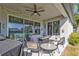 Inviting outdoor patio with ceiling fan, outdoor seating, and views of lush backyard at 206 Santarem Cir, Punta Gorda, FL 33983