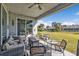 Spacious patio area with ceiling fan, outdoor furniture, and beautifully landscaped yard at 206 Santarem Cir, Punta Gorda, FL 33983