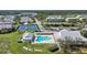 Wide aerial shot of the community featuring a pool, clubhouse, and pickleball courts at 2061 Willow Hammock Cir # 105, Punta Gorda, FL 33983