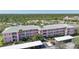 Aerial view of building with carports, landscaping, and community parking at 2061 Willow Hammock Cir # 105, Punta Gorda, FL 33983
