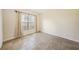 Well-lit bedroom featuring neutral walls and large window providing natural light at 2061 Willow Hammock Cir # 105, Punta Gorda, FL 33983