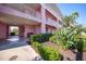 Entrance to condominium features a private entrance, lovely landscaping, and shade at 2061 Willow Hammock Cir # 105, Punta Gorda, FL 33983