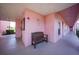 Entrance to the building features a shaded walkway with a bench, plants, and security at 2061 Willow Hammock Cir # 105, Punta Gorda, FL 33983