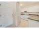 Kitchen features a stainless steel sink, tile flooring, and white appliances at 2061 Willow Hammock Cir # 105, Punta Gorda, FL 33983