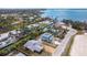 Aerial view of an upscale neighborhood showcasing a home near the water, surrounded by lush tropical foliage at 231 Winson Ave, Englewood, FL 34223