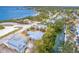 Aerial view of a gray home with a defined property line near the water and lush foliage at 231 Winson Ave, Englewood, FL 34223
