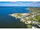 Expansive aerial view showcasing a waterfront property with clear ocean waters and lush coastal scenery at 231 Winson Ave, Englewood, FL 34223