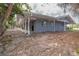 The backyard shows tropical trees and landscaping, along with a covered porch and room for outdoor activities at 231 Winson Ave, Englewood, FL 34223