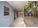 A covered porch stretches alongside the house, providing ample space for outdoor lounging and enjoyment of the scenery at 231 Winson Ave, Englewood, FL 34223