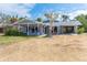 Charming single-story home featuring a well-maintained exterior and ample yard space on a sunny day at 231 Winson Ave, Englewood, FL 34223