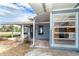 Exterior shot of home with covered porch that reveals an inviting interior through bright and clear windows at 231 Winson Ave, Englewood, FL 34223