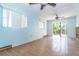 Living area featuring tile floor, window views, ceiling fan, and sliding door exit at 231 Winson Ave, Englewood, FL 34223