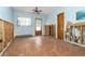 A simple living room features a standard ceiling fan, a window, and an entry door at 231 Winson Ave, Englewood, FL 34223