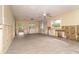 A large living space features new floors, a ceiling fan, and multiple windows for natural light at 231 Winson Ave, Englewood, FL 34223