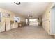 A flooded living space features new floors, a ceiling fan, and an in-window AC unit at 231 Winson Ave, Englewood, FL 34223