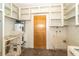 A utility room features a water heater, ample shelving, and tiled flooring at 231 Winson Ave, Englewood, FL 34223