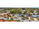 Aerial shot showing a residential neighborhood with mature trees, solar panels, and carports at 2521 Clipper Ship Way, Sarasota, FL 34231
