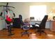 Spacious basement with exercise machine, desk, and two rolling office chairs at 2521 Clipper Ship Way, Sarasota, FL 34231