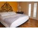 Bright bedroom featuring an iron headboard, bamboo floors, and french doors at 2521 Clipper Ship Way, Sarasota, FL 34231