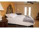 Bright bedroom featuring an iron headboard, bamboo floors, and french doors at 2521 Clipper Ship Way, Sarasota, FL 34231