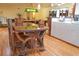 Unique dining table with a glass top and wooden chairs at 2521 Clipper Ship Way, Sarasota, FL 34231