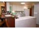 Bright kitchen features white cabinets, stainless steel appliances, and a unique live edge breakfast bar at 2521 Clipper Ship Way, Sarasota, FL 34231