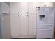 Modern kitchen with white cabinets, microwave, and stainless steel refrigerator with water dispenser at 2521 Clipper Ship Way, Sarasota, FL 34231