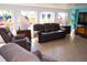 Cozy living room with comfortable seating, tile floors, and lots of natural light at 2521 Clipper Ship Way, Sarasota, FL 34231
