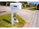 Charming mailbox with pelican statue, decorative ironwork, and clear house numbers, adding character to the front yard at 2521 Clipper Ship Way, Sarasota, FL 34231
