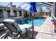 Backyard enclosed pool area with hot tub and waterfall feature at 2521 Clipper Ship Way, Sarasota, FL 34231