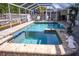 Enjoy this screened pool with spa, dolphin statue, and brick-paved patio for year-round outdoor entertaining at 2521 Clipper Ship Way, Sarasota, FL 34231