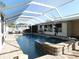 A spacious pool with a screened enclosure, a hot tub with colorful trim, and a poolside fountain, offering a relaxing retreat at 2521 Clipper Ship Way, Sarasota, FL 34231