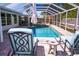 Backyard enclosed pool area with hot tub and waterfall feature at 2521 Clipper Ship Way, Sarasota, FL 34231