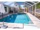 Backyard enclosed pool area with hot tub and waterfall feature at 2521 Clipper Ship Way, Sarasota, FL 34231